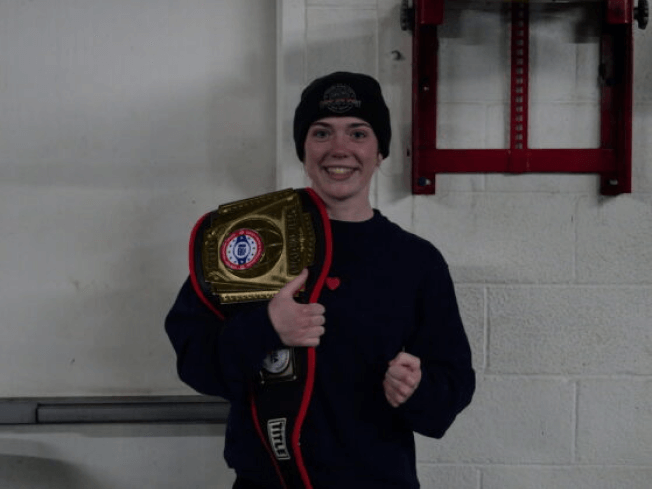 Rian McCreary holding a championship belt